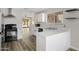 Well-lit kitchen with white cabinets, updated appliances, and a breakfast bar at 2625 E Beverly Rd, Phoenix, AZ 85042