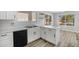 Bright kitchen features white cabinets, updated appliances, and a breakfast bar overlooking the outdoors at 2625 E Beverly Rd, Phoenix, AZ 85042