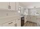 Bright kitchen with white cabinetry, countertops, stainless steel dishwasher, and a modern faucet at 2625 E Beverly Rd, Phoenix, AZ 85042