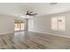 Bright living room featuring wood-look floors, contemporary ceiling fan and sliding glass door at 2625 E Beverly Rd, Phoenix, AZ 85042