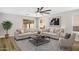 Contemporary living room with plush sofas, modern rug, and stylish ceiling fan at 2625 E Beverly Rd, Phoenix, AZ 85042