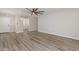 Spacious living room featuring wood-look floors and a contemporary ceiling fan at 2625 E Beverly Rd, Phoenix, AZ 85042