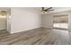 Open concept living room featuring wood-look floors and sliding glass door at 2625 E Beverly Rd, Phoenix, AZ 85042