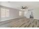 Bright living room featuring wood-look floors, contemporary ceiling fan and natural light at 2625 E Beverly Rd, Phoenix, AZ 85042