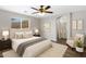 Cozy main bedroom with large window, ensuite bathroom, ceiling fan and neutral decor at 2625 E Beverly Rd, Phoenix, AZ 85042