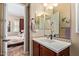 Bathroom sink with stylish fixtures and mirror, view of adjacent bedroom at 29159 N 128Th Ln, Peoria, AZ 85383