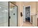 Bathroom featuring glass enclosed shower, tile flooring, and a walk-in closet at 29159 N 128Th Ln, Peoria, AZ 85383