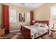 Cozy bedroom with wood floors, plantation shutters, ceiling fan, and comfortable furnishings at 29159 N 128Th Ln, Peoria, AZ 85383