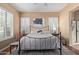 Spacious bedroom featuring plantation shutters, ceiling fan, wood floor and stylish rug at 29159 N 128Th Ln, Peoria, AZ 85383