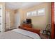 Bedroom featuring a bed, chair, ceiling fan, and plantation shutters at 29159 N 128Th Ln, Peoria, AZ 85383