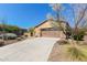 Inviting single-story home with a spacious driveway and well-maintained desert landscaping at 29159 N 128Th Ln, Peoria, AZ 85383