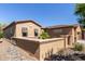 Single-story home featuring shuttered windows and a quaint courtyard with desert landscaping at 29159 N 128Th Ln, Peoria, AZ 85383
