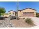 Charming single-story home featuring a two-car garage and low-maintenance desert landscaping at 29159 N 128Th Ln, Peoria, AZ 85383