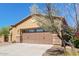 The home has a two-car garage with beautiful stone accents and desert landscaping at 29159 N 128Th Ln, Peoria, AZ 85383
