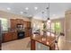 Spacious kitchen featuring an island, tile backsplash, and access to the dining area at 29159 N 128Th Ln, Peoria, AZ 85383