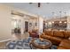 Open-concept living room featuring tile floors, a ceiling fan, and a dining area at 29159 N 128Th Ln, Peoria, AZ 85383