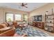 Spacious living room featuring tile floors, a ceiling fan, and ample natural light at 29159 N 128Th Ln, Peoria, AZ 85383