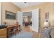 Home office adjacent to living room with plenty of natural light and workspace at 29159 N 128Th Ln, Peoria, AZ 85383