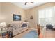 Comfortable home office with a cozy couch and shuttered window for privacy at 29159 N 128Th Ln, Peoria, AZ 85383