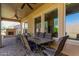 Covered outdoor patio includes a dining area, a fireplace, and ample seating, perfect for entertaining at 29159 N 128Th Ln, Peoria, AZ 85383