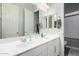 Bright bathroom with double sinks, white cabinets, and large mirror at 3081 E Desert Broom Pl, Chandler, AZ 85286