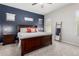 Bedroom features blue accent wall, patterned rug, and wood furniture at 3081 E Desert Broom Pl, Chandler, AZ 85286