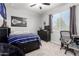 Comfortable bedroom features a ceiling fan, a window for natural light, and a cool color palette at 3081 E Desert Broom Pl, Chandler, AZ 85286