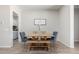 Charming dining room with a wooden table, bench seating, and stylish blue upholstered chairs at 3081 E Desert Broom Pl, Chandler, AZ 85286