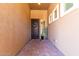 Covered front entrance featuring a secure screen door, neutral color palette, and brick flooring at 3081 E Desert Broom Pl, Chandler, AZ 85286