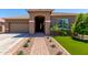 Charming single-story home featuring a low-maintenance front yard with vibrant artificial turf and desert landscaping at 3081 E Desert Broom Pl, Chandler, AZ 85286