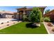 View of a landscaped front yard featuring vibrant artificial turf and desert landscaping for low maintenance at 3081 E Desert Broom Pl, Chandler, AZ 85286