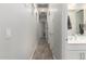 Hallway with wood-look tile leading to a bathroom and other rooms at 3081 E Desert Broom Pl, Chandler, AZ 85286