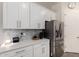 Modern kitchen featuring white cabinets, stainless steel appliances, and a decorative tile backsplash at 3081 E Desert Broom Pl, Chandler, AZ 85286