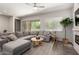 Cozy living room with a large sectional sofa, round coffee table, and access to the outdoor patio at 3081 E Desert Broom Pl, Chandler, AZ 85286