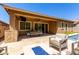 Inviting covered patio featuring an outdoor kitchen, dining area, and cozy seating around a fire pit at 3081 E Desert Broom Pl, Chandler, AZ 85286
