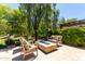 Backyard patio with comfortable seating around a blue glass fire pit at 3081 E Desert Broom Pl, Chandler, AZ 85286