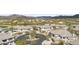 An aerial view showcases homes and a golf course set within a desert landscape, with mountains in the background at 33575 N Dove Lakes Dr # 2033, Cave Creek, AZ 85331