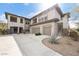 Stunning three-story home featuring a three-car garage and desert landscaping at 33575 N Dove Lakes Dr # 2033, Cave Creek, AZ 85331