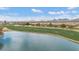 Picturesque golf course view with a pond, lush green fairways, and mountain backdrop at 33575 N Dove Lakes Dr # 2033, Cave Creek, AZ 85331