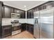 Well-equipped kitchen with stainless steel appliances, granite countertops, and sleek dark cabinets at 33575 N Dove Lakes Dr # 2033, Cave Creek, AZ 85331