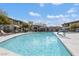 Community pool with lounge chairs and well-manicured landscaping at 33575 N Dove Lakes Dr # 2033, Cave Creek, AZ 85331
