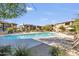 A large pool surrounded by lounge chairs and well-maintained landscaping at 33575 N Dove Lakes Dr # 2033, Cave Creek, AZ 85331
