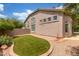 Well-maintained backyard featuring artificial grass, lush foliage and privacy wall at 3514 E Desert Broom E Way, Phoenix, AZ 85044