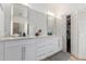 Elegant bathroom featuring marble countertops, white cabinetry and glass block shower, offering a spa-like experience at 3514 E Desert Broom E Way, Phoenix, AZ 85044