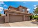 Spacious three-car garage with a tile roof and neutral stucco, providing ample parking and storage space at 3514 E Desert Broom E Way, Phoenix, AZ 85044