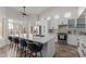 Modern kitchen with a large marble island, stainless steel appliances and white cabinetry, perfect for cooking at 3514 E Desert Broom E Way, Phoenix, AZ 85044