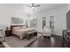 Serene main bedroom with wood floors, plantation shutters and French doors leading to the outdoor living area at 3514 E Desert Broom E Way, Phoenix, AZ 85044