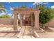 Inviting outdoor living space with a stone fireplace feature and decorative pergola at 3514 E Desert Broom E Way, Phoenix, AZ 85044