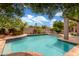 Sparkling pool with lush landscaping and a built in seating area at 3514 E Desert Broom E Way, Phoenix, AZ 85044