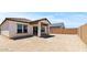 The home features a dirt backyard with block fence and covered patio at 3913 S 233Rd Ln, Buckeye, AZ 85326
